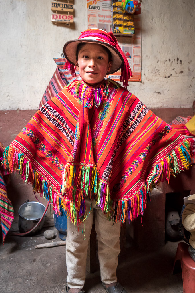 Boy from the Patacancha valley in a traditional red poncho