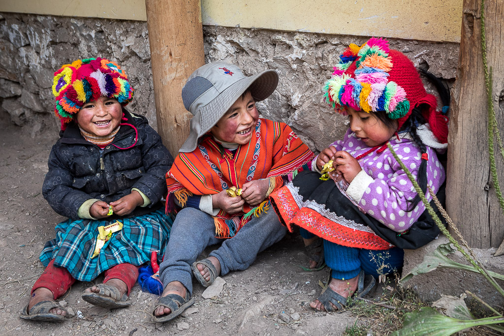 Children from the Patacancha valley in colorful chullo hats and traditional clothing