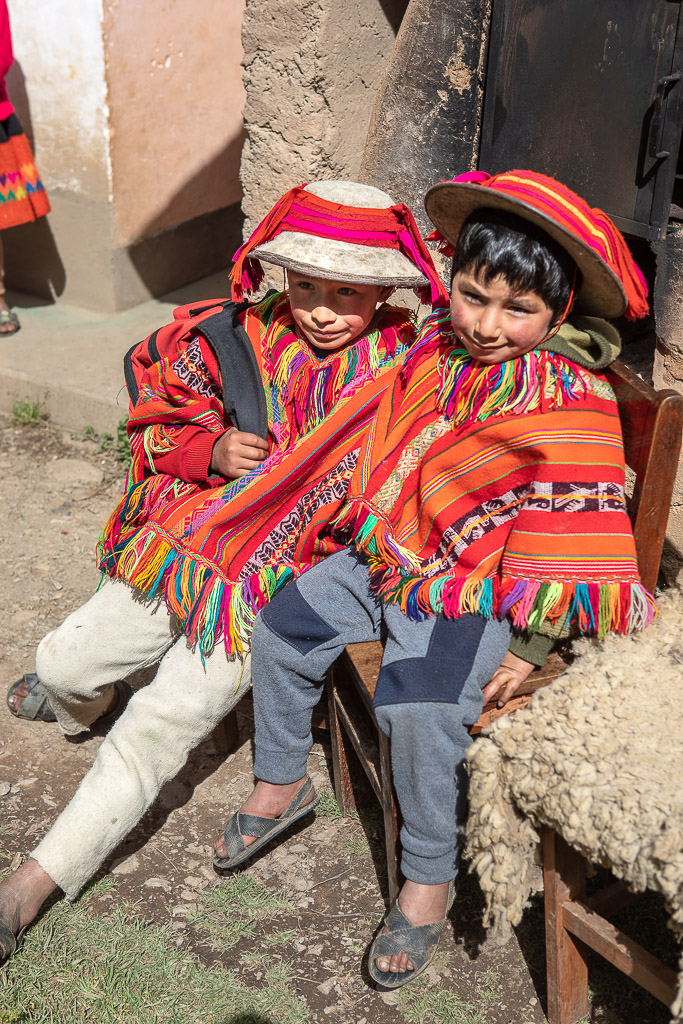 Two boys in hand-woven ponchos in the Patacancha valley